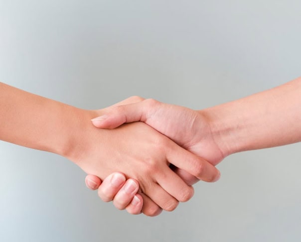Two people shaking hands, representing an Alertify partnership