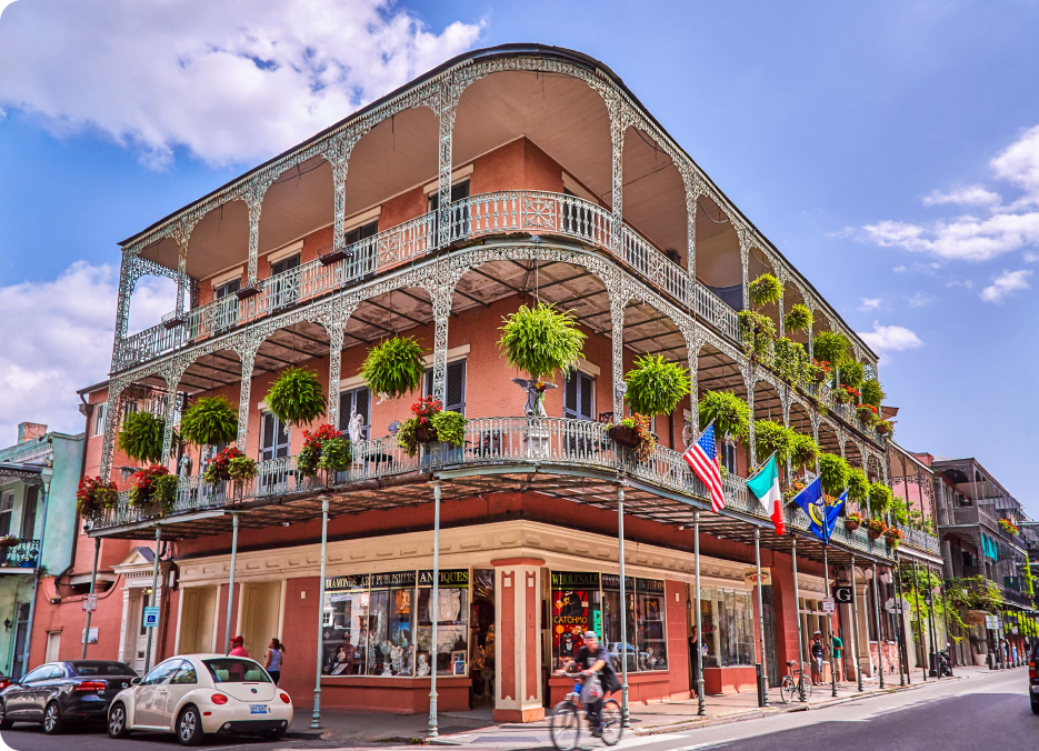 A classic New Orleans French Quarter building with wrought-iron balconies, home to many short-term rentals