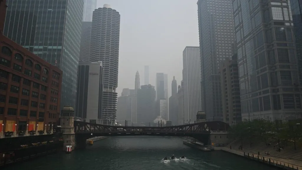 The Chicago skyline and river reduced to grey silhouettes by dense wildfire haze.
