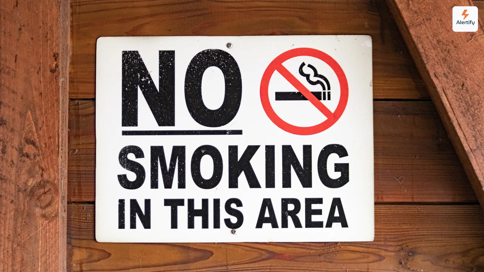 No smoking sign mounted on the wooden wall of a rental property