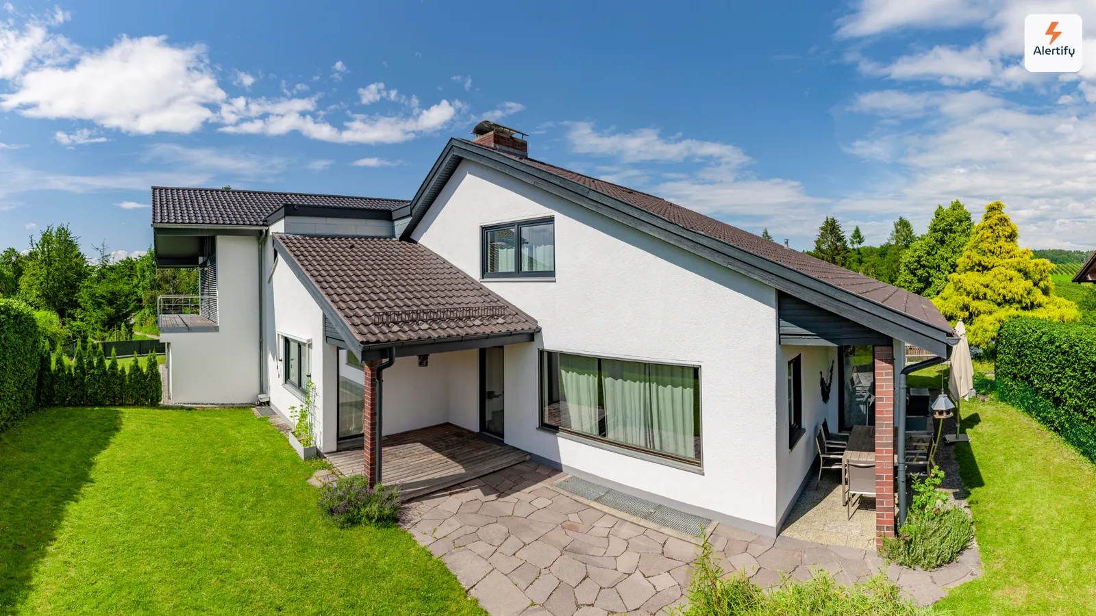 Empty white single-family rental house with a lawn and patio between tenancies